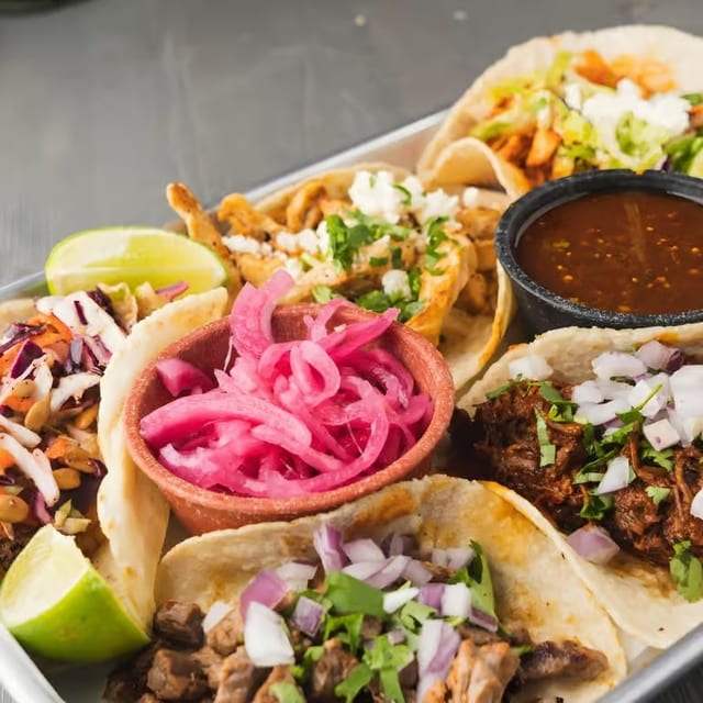 Cochinita Pibil Tacos (Pork Cushion Marinated for 24 Hours with Banana Leaves with Our Famous Grandma's Recipe).